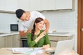 My dear. Loving smiling husband massaging shoulders of his beautiful wife in the kitchen