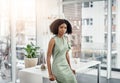 My door is always open. Cropped portrait of an attractive young businesswoman leaning against her desk in the office. Royalty Free Stock Photo