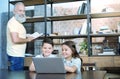 Mindful granddad looking at kids playing on laptop Royalty Free Stock Photo