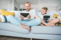 My father funs from PC games just like me.Father and son emotionally playing with electronic devices : tablet and gamepad sitting