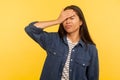 My fault! Portrait of sorrowful upset girl in denim shirt doing facepalm gesture, blaming herself for forgotten event