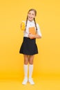 This is my favorite taste. Healthy nutrition. Schoolgirl holding juice bottle on yellow background. Quenching thirst