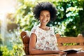 My favourite way to spend free time. Portrait of a young woman reading a book on a bench outdoors. Royalty Free Stock Photo