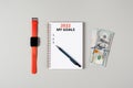 2022 my financial goals banner. Notepad, pen, stack of money and a cup of black coffee isolated on gray background Royalty Free Stock Photo