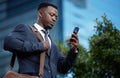 When is my first meeting. a young businessman using a phone in the city. Royalty Free Stock Photo