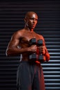 My focus is unmatched. Studio shot of an athletic young man working out using dumbbells against a grey background. Royalty Free Stock Photo