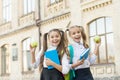 My funny friend. back to school. two small girls ready to study. do homework together. sisters at break with apple Royalty Free Stock Photo