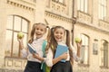 My funny friend. back to school. two small girls ready to study. do homework together. sisters at break with apple Royalty Free Stock Photo