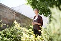 My garden - a place my thoughts love to wander. A cropped shot of a beautful young woman drinking coffee in her garden. Royalty Free Stock Photo