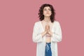 My God please help me. Portrait of worried hopeful beautiful brunette young woman with curly hairstyle in casual style standing, Royalty Free Stock Photo