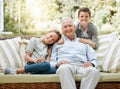 My grandchildren have so much love and respect for me. a senior man sitting outside with his two grandchildren. Royalty Free Stock Photo