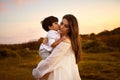 My greatest blessings call me Mom. a son kissing his young mother on the cheek outdoors. Royalty Free Stock Photo