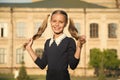 My hair needs a hairdresser. Little girl in pigtails outdoors. Happy child hold long blond hair. Hair and beauty salon