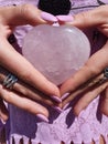 My Hands Holding a Heart of Rose Quartz Gemstone Polished Gems Stones Rocks Nails BOHO Beach Lotus Ring Royalty Free Stock Photo