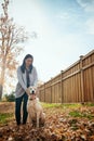 My heart belongs to my pup. an attractive young woman having fun with her dog on an autumn day in a garden. Royalty Free Stock Photo