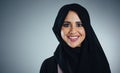 My hijab, my identity. Studio portrait of a young muslim businesswoman against a grey background. Royalty Free Stock Photo