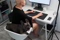 French bulldog looking at the camera with sticking out tongue while sitting at the chair Royalty Free Stock Photo