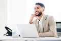 My ideas are coming into fruition. a handsome young businessman sitting alone in the office and using his laptop. Royalty Free Stock Photo