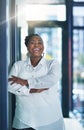 My job makes me happy every day. Portrait of a happy businesswoman posing in the office with her arms folded.