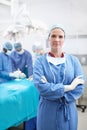 My job is stressful but rewarding. Portrait of a serious surgeon standing with her arms crossed during a