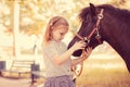 My lovely friend. Closeup portrait cute little kid girl holding cuddling her pony horse isolated outdoors outside green park