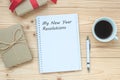 My New Year Resolutions word with notebook, black coffee cup and pen on wooden table, Top view and copy space. New Start, Goals, S Royalty Free Stock Photo