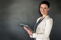 My office in the palm of my hand. Studio portrait of a businesswoman standing with a tablet against a grey background. Royalty Free Stock Photo