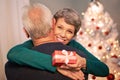 My own Santa Claus. Portrait of a happy mature woman embracing her husband after receiving a Christmas gift from him. Royalty Free Stock Photo