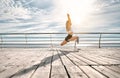 My perfect morning. Sporty disabled athlete woman in sportswear with prosthetic leg standing in yoga pose on the bridge in front Royalty Free Stock Photo