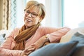 My retirement brought me a lot of happiness. Portrait of a happy mature woman relaxing on the sofa at home. Royalty Free Stock Photo