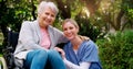 She is always by my side. a cheerful elderly woman in a wheelchair spending time with her daughter outside in a park. Royalty Free Stock Photo