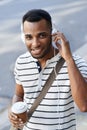 This is my song. A handsome african american businessman standing the city while listening to some music. Royalty Free Stock Photo