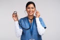 My stethoscope, my jewellery. Portrait of a young doctor using a stethoscope against a white background.