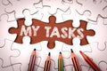 MY TASKS. White puzzle pieces and colored pencils Royalty Free Stock Photo