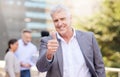 My team have what it takes to be great. a mature businessman standing outside and showing a thumbs up while his Royalty Free Stock Photo