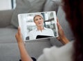 My therapist is always on call. an unrecognisable woman sitting and using a digital tablet for an online therapy session Royalty Free Stock Photo