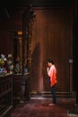 Woman praying in front of an altar