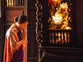 Woman praying in front of an altar