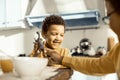 During breakfast two kids playing with toy dinosaur. Royalty Free Stock Photo