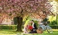 My treasure. Romantic proposal. Enjoying their perfect date. Couple relaxing in park with bicycle. Romantic picnic with