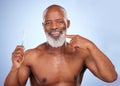 My trusted brand has never failed me. Studio portrait of a mature man brushing his teeth against a blue background. Royalty Free Stock Photo