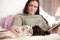 My two best friends. A woman and her pet cat and dog relaxing in bed together. Royalty Free Stock Photo