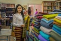 Myanma woman shopping traditional cloting of Amarapura at local weaving fabric shop in Mandalay Myanmar