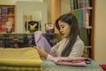 Myanma woman shopping traditional cloting of Amarapura at local weaving fabric shop in Mandalay Myanmar