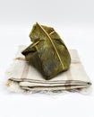 Myanmar or Burmese traditional street food, zongzi called mont phet htok made of rice, sugar and coconut. Isolated on white