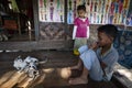 Myanmar - cat and child inside a tradicional home Royalty Free Stock Photo