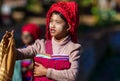 Intha tribal woman selling silk cloths to tourist in Inle, Myanmar