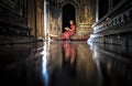 Myanmar - December 5, 2016: A Myanmar Little Novice Monk reading buddhism book in front of the door of temple, Shan District