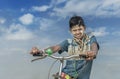 Portrait of local village boy riding cycle, Yangon, Myanmar