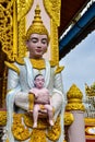 Myanmar goddess statue holding child statue Royalty Free Stock Photo